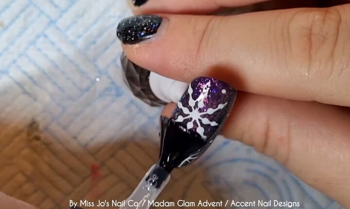 how to create a festive snowflake nail design in 8 easy steps, Applying top coat