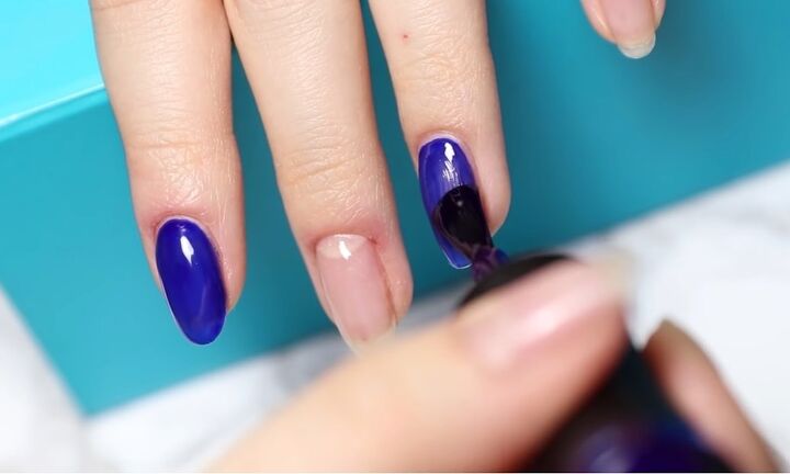 how to diy confetti nails for new year s eve, Applying blue nail polish