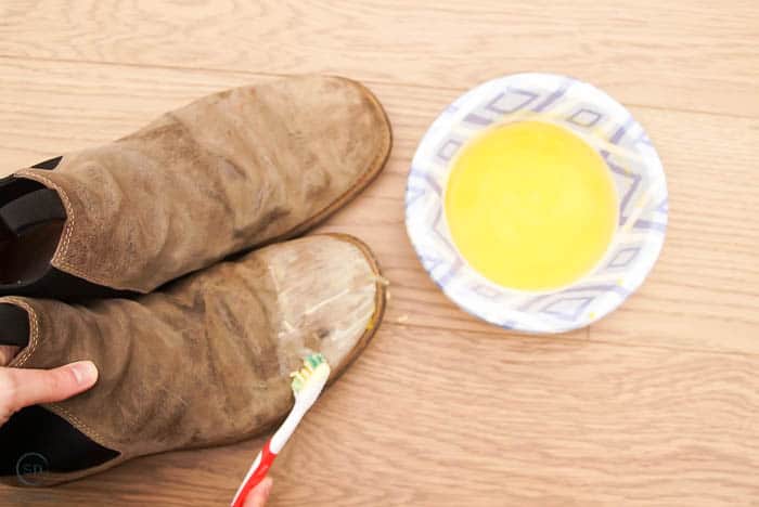how to waterproof leather boots, use toothbrush to apply beeswax to leather boots for waterproofing
