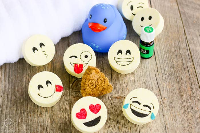 how to make hand sanitizer, The final product of this bath bombs recipe are these adorable kids bath bombs with emoji faces A fun show showing the completed bath bombs and other bath essentials
