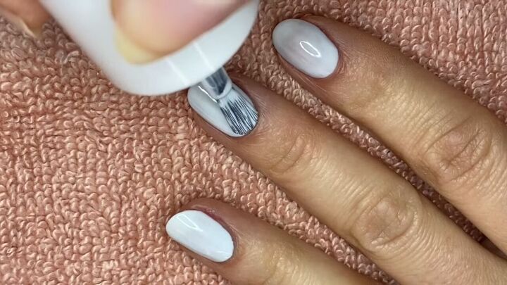 how to do an easy reverse half moon french manicure, Painting nails with a second coat