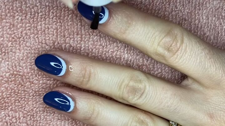 how to do an easy reverse half moon french manicure, Applying cuticle oil