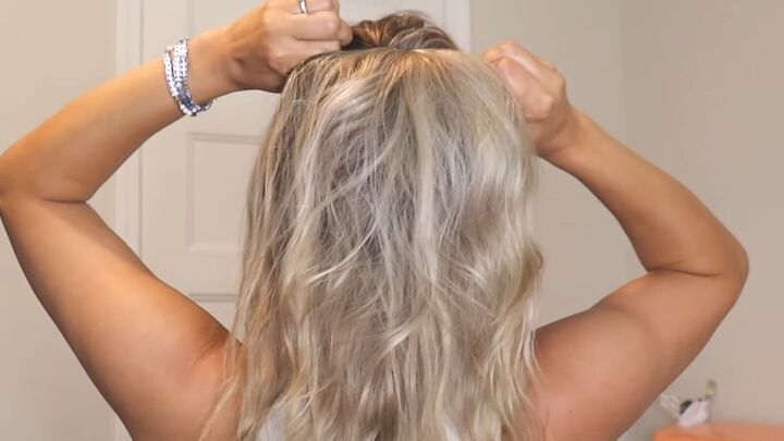 super easy 1 minute hack for a voluminous ponytail, Flipping top section over