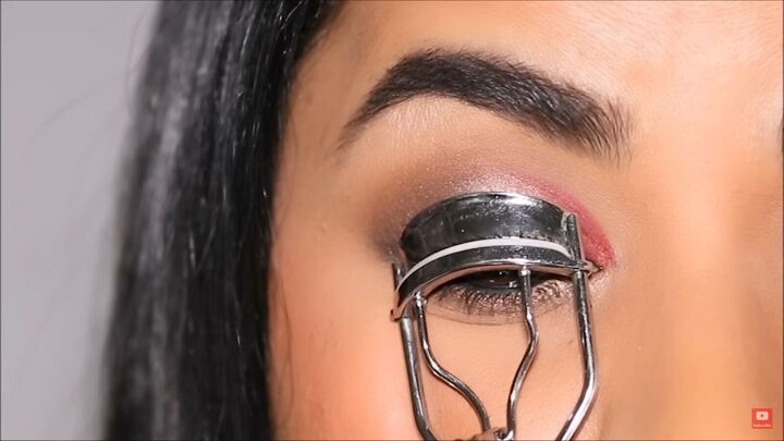 create a glam eye makeup look using this easy v technique, Curling lashes