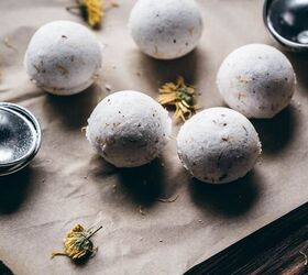 diy fizzy calendula rose bath bombs, white bath bombs rest on brown parchment paper