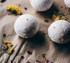 diy fizzy calendula rose bath bombs, 5 diy rose bath bombs rest on natural parchment paper scattered with dried calendula flowers