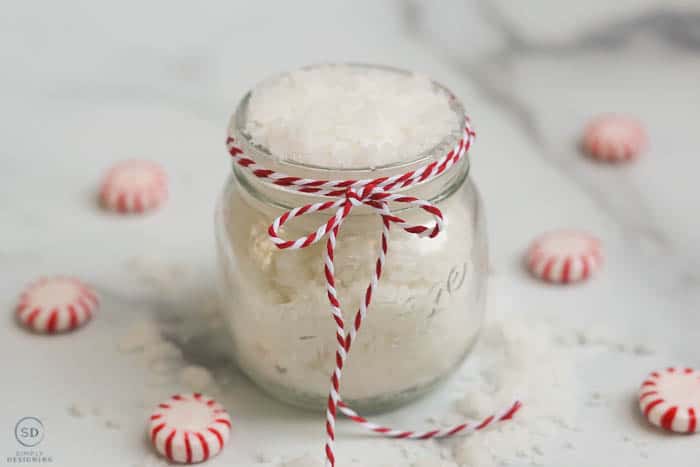 peppermint sugar scrub, Peppermint Sugar Scrub in a glass jar with red and white twine around the jar