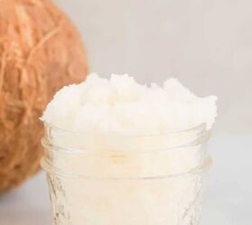 peppermint sugar scrub, vertical photo of coconut body scrub in a small glass mason jar with a partial view of a coconut in the background