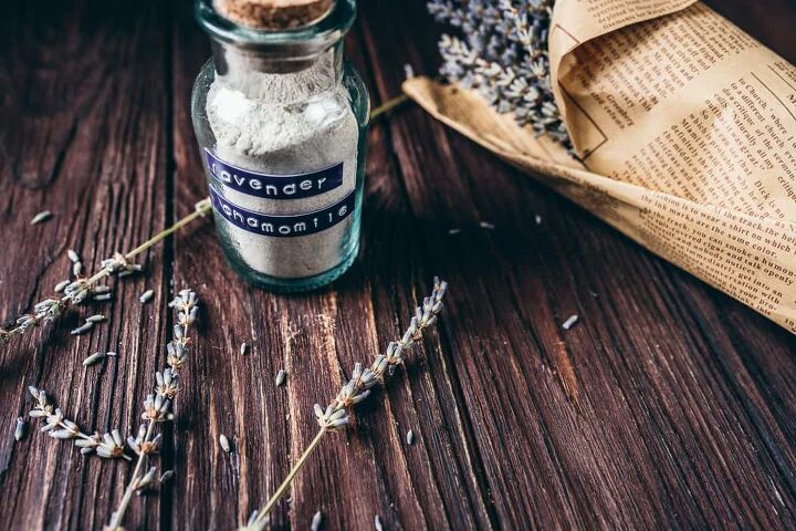 lavender chamomile facial cleansing grains recipe, a bottle of facial cleansing grains resting on a dark wooden tabletop