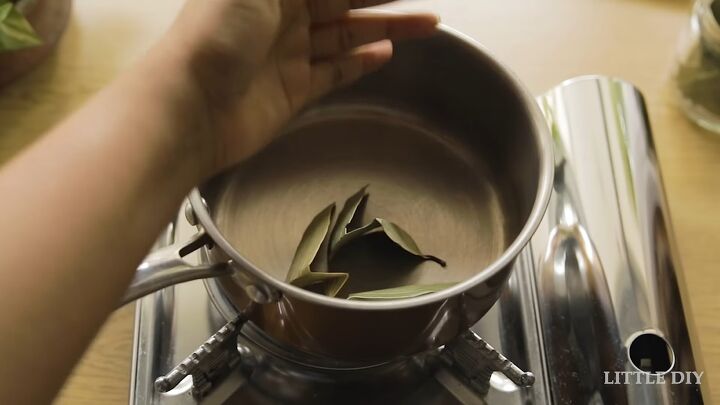 how to make a bay leaf spray and a neem scalp mask for healthy hair, Adding bay leaves to pot