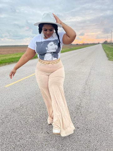 1 accessory you need for the houston rodeo morgan b styles, morgan b wearing white gold chain fedora hat with graphic selena t shirt and nude overflow bell pants