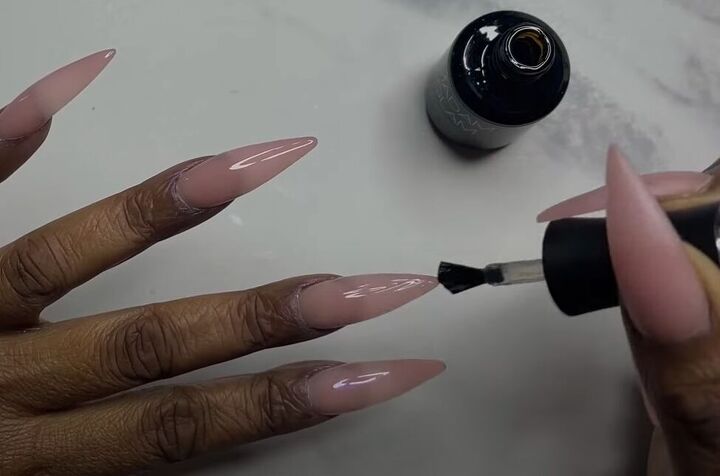 how to diy tiktok trending pink glazed donut nails, Finishing with top coat