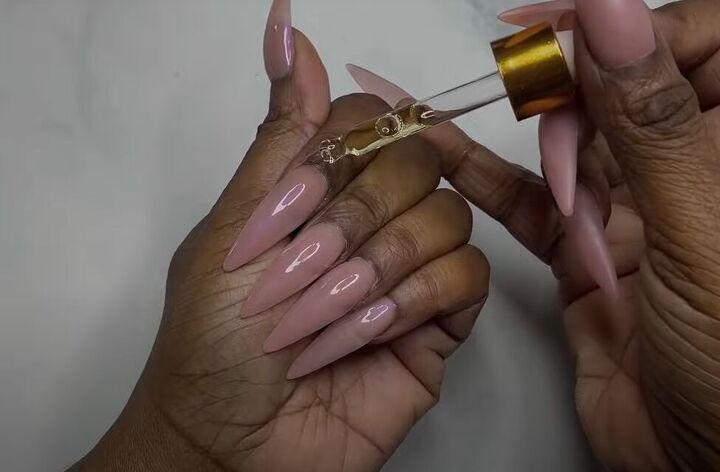 how to diy tiktok trending pink glazed donut nails, Applying cuticle oil