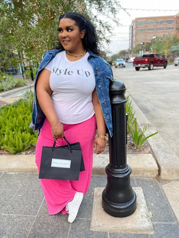 1 pant 3 ways how to style the pink overflow pants morgan b style, Morgan B holding shopping bags while wearing a graphic t shirt and pink overflow pants
