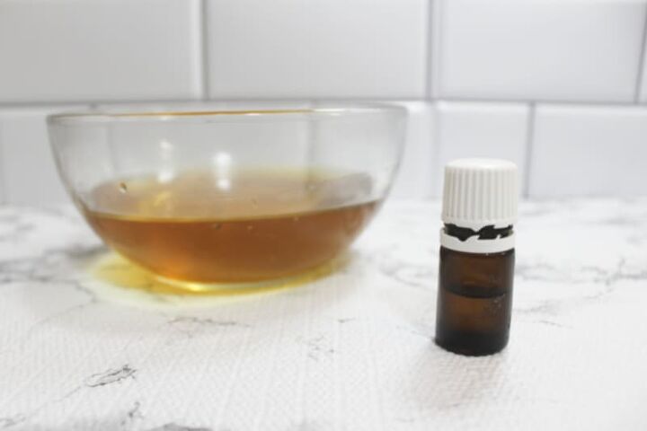 sunburn salve recipe, an essential oil bottle near a bowl of oil