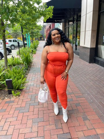 spring 2023 color we are loving morgan b styles, Morgan B wearing Orange Flaunt It Ruched Set with white cowboy boots and a mini croc skin bucket bag