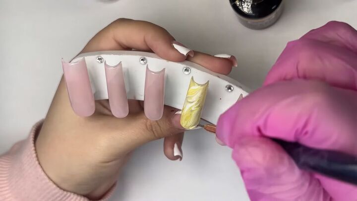 how to create cute french tip yellow nails for spring, Swirling the colors with a liner brush