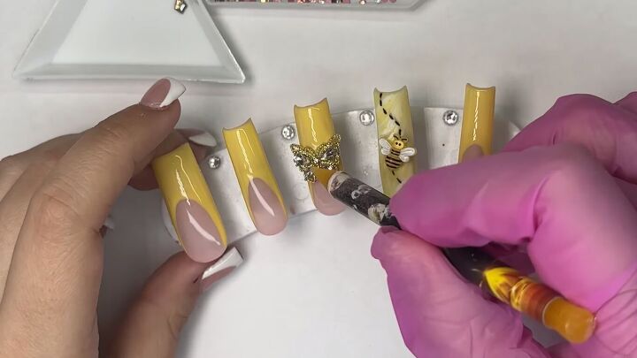 how to create cute french tip yellow nails for spring, Applying charms to the nails
