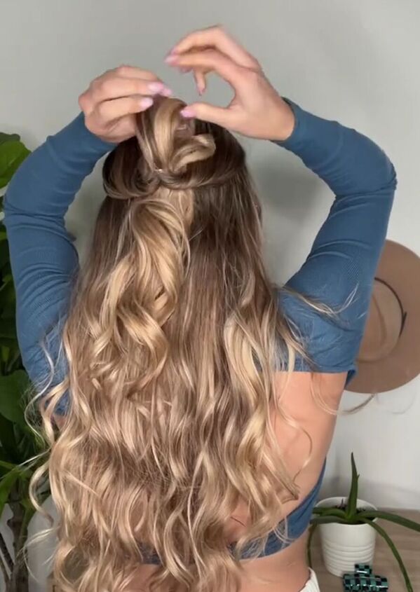 try this easy half up claw clip hack, Pulling ponytail through hole