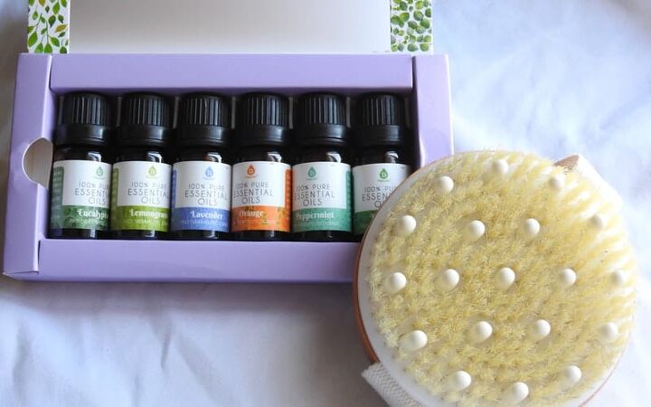 coconut oil body butter, a box of essential oils and exfoliating scrubber