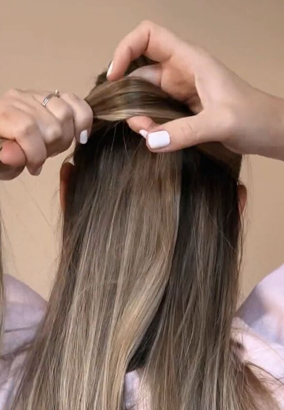Half-up half-down hairstyle with soft waves and light blonde highlights