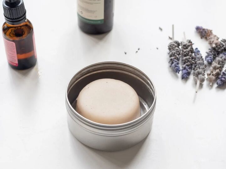 how to use a lotion bar recipe for easy diy bars, Essential oil bottles and lavendar flowers with lotion bar in metal tin