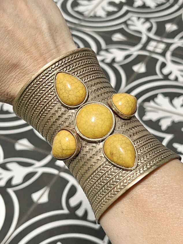 tips on how to wear a cuff bracelet with style, How to Wear a Cuff Bracelet with Style A gold cuff bracelet filled with yellow stones