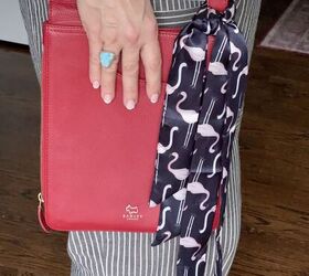 how to tie and style a scarf on your handbag or purse, A red crossbody bag with a flamingo patterned twilly scarf