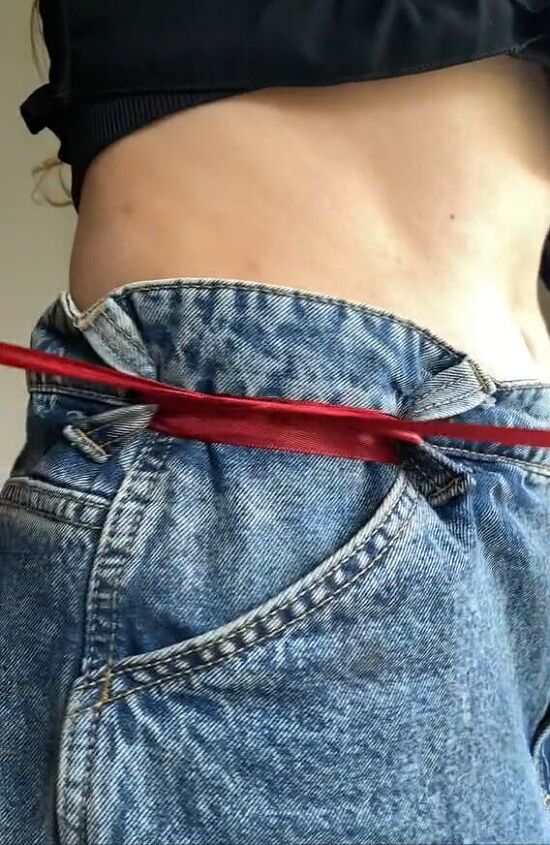 the easiest and trendiest way to tighten oversized jeans, Tying ribbon