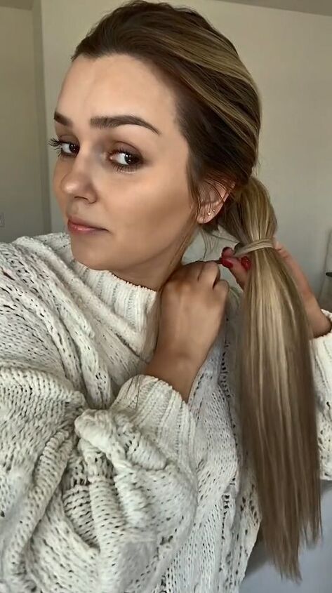 sleek ponytail tutorial that covers all rubber bands, Wrapping hair over elastic
