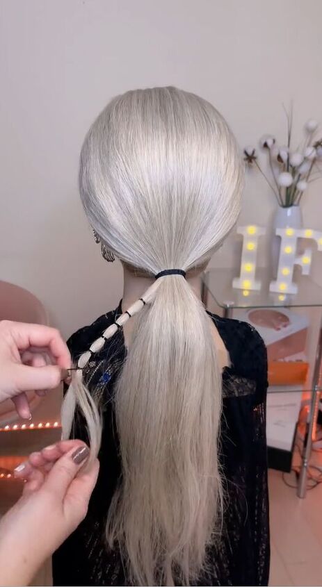 upgrade your ponytail with this unique finish, Adding hair elastics