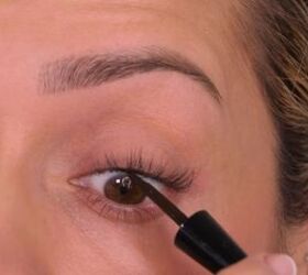 Applying eyeliner