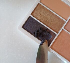 Scraping eyeshadow from the palette 