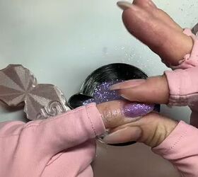 Applying dip powder to the nails