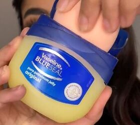 Dipping beauty blender into Vaseline 