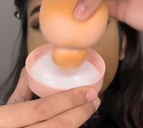 Dipping a beauty blender into setting powder