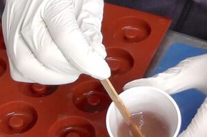 Stick a popsicle stick in a cup of resin to make this deliciously adorable gift idea