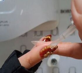 red and gold nails, Applying a top coat