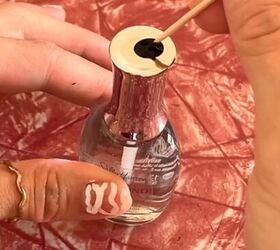 She dips a toothpick into some black nail polish for an idea you'll want to try out in October...