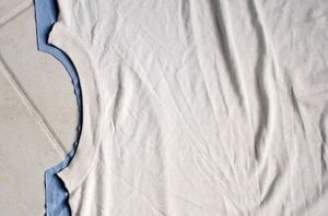 She places an old t-shirt over some fabric for this fun and fashionable idea