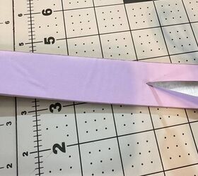 This cute purple belt was too long with the holes in the wrong place, so she grabbed a pair of scissors and did this...