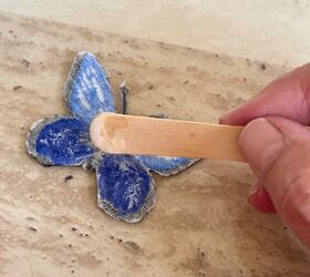 She puts glue on a popsicle stick for this extra-cute idea