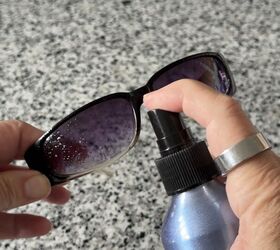 She sprays her sunglasses before touching the lenses