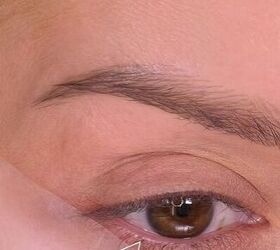 She puts the tape beside her eye at this angle