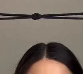 She ties 2 rubber bands together for this unexpectedly cute half-up hairdo