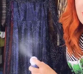 She’s spraying her dress with hairspray—and there’s a reason